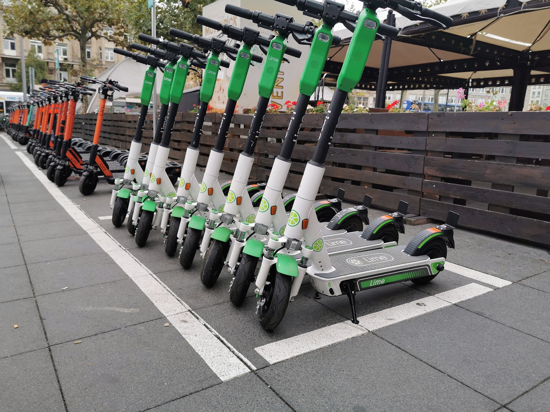 Lime E-Scooter stehen nebeneinander auf der Straße